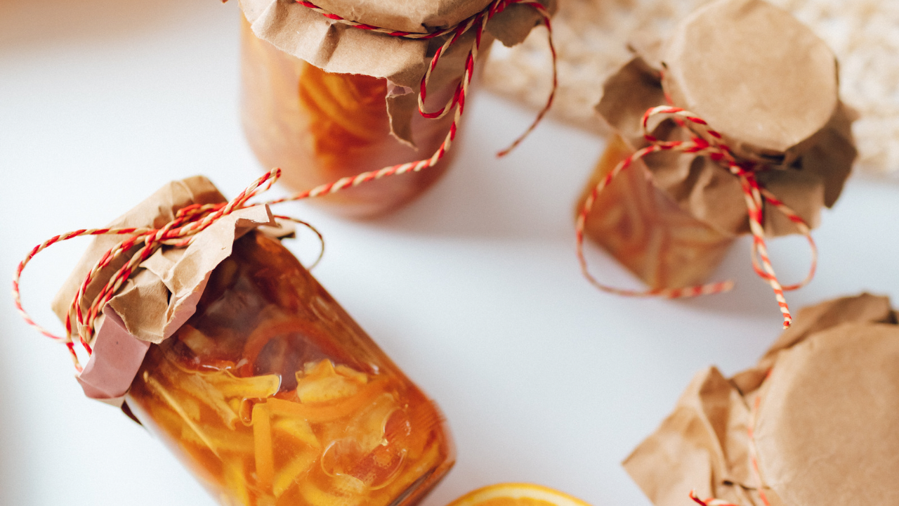 Jars of marmalade with paper plates tied with string Easy home-made Marmalade Recipe